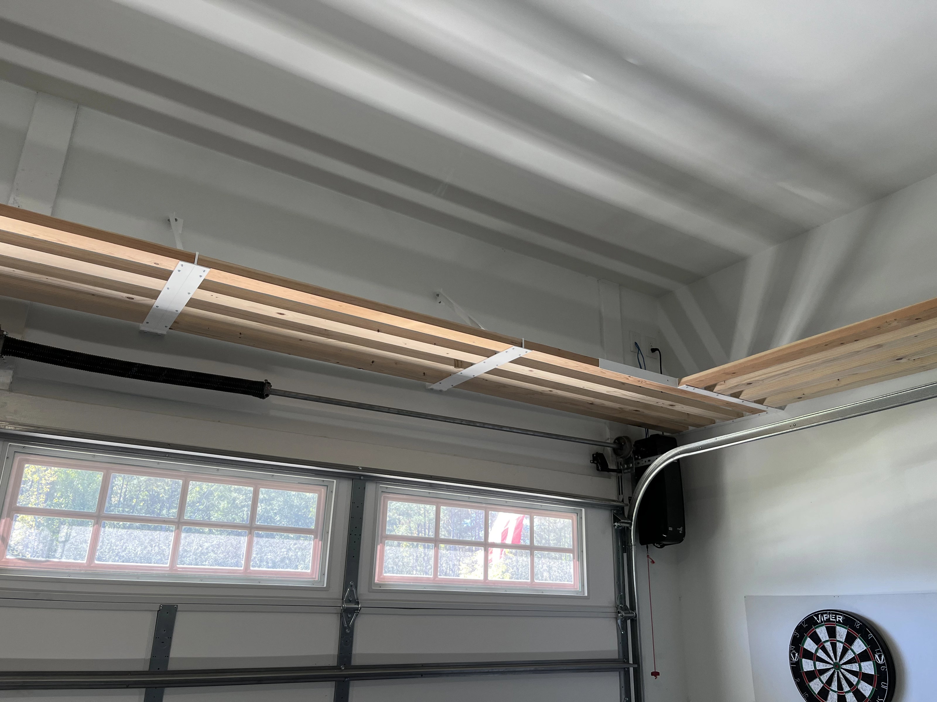 corner garage shelving above garage door installed by top tier shelving company in garner nc