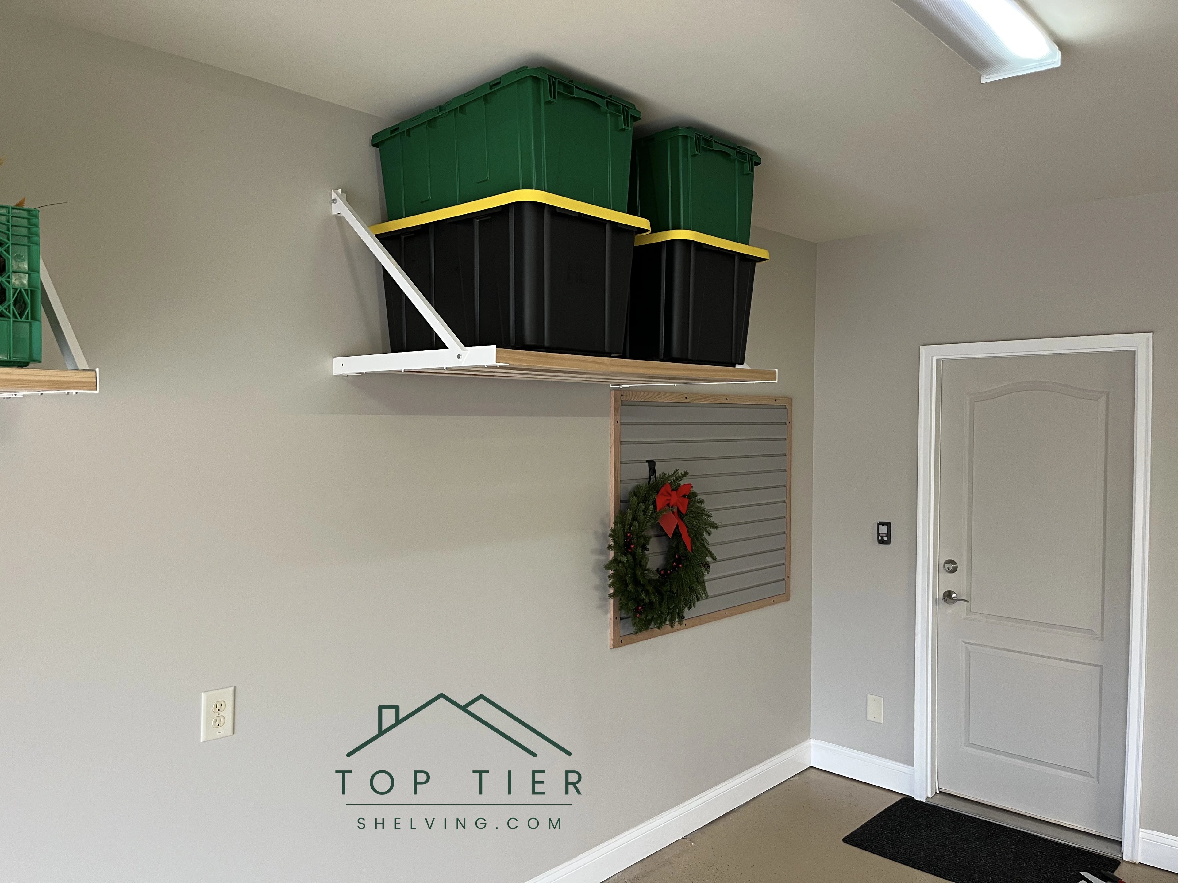organized residential garage with Top Tier SHelving wall-mounted and clear floorspace