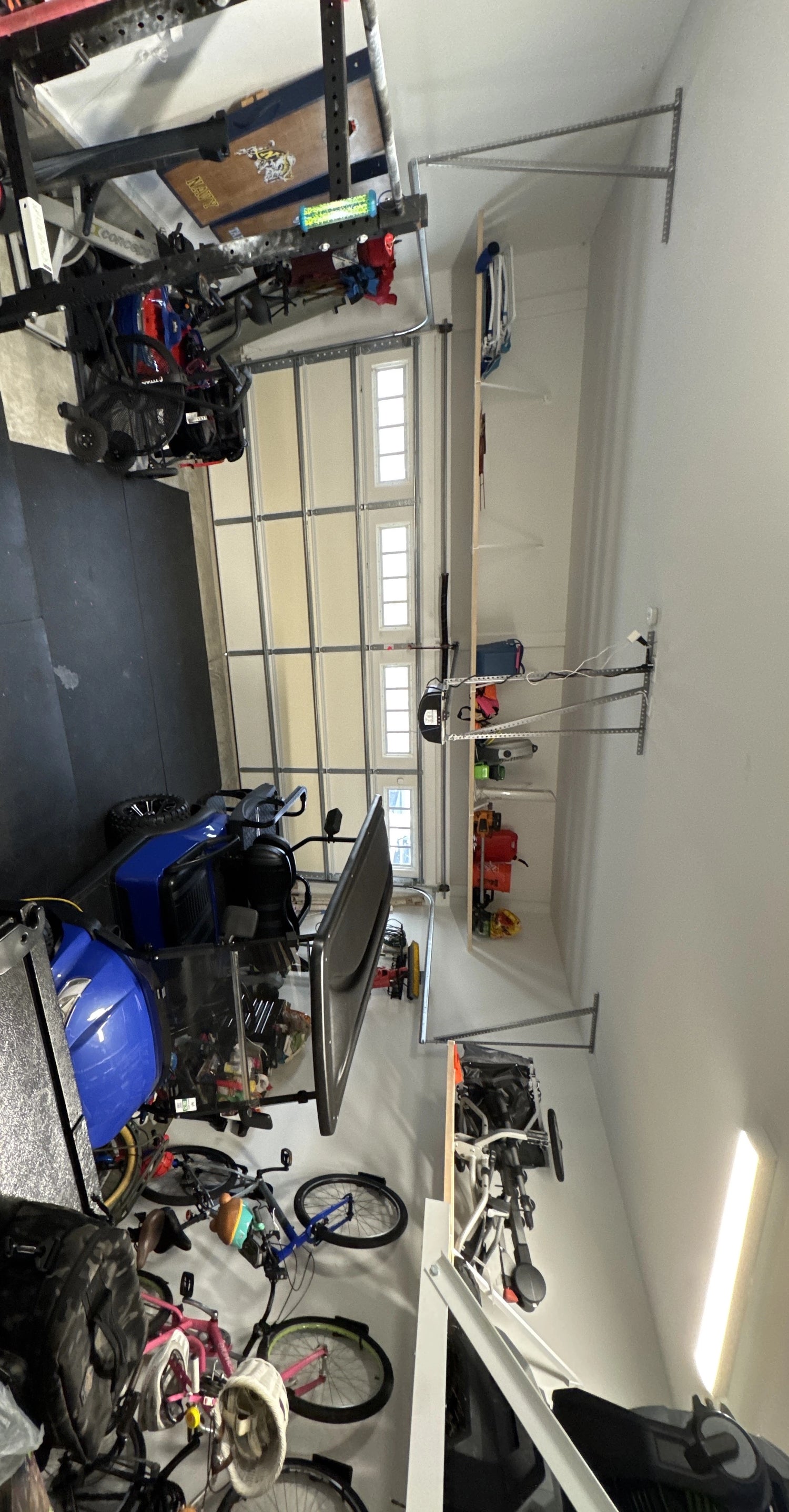 customer photo of a professional shelving installation in an organized garage and home gym