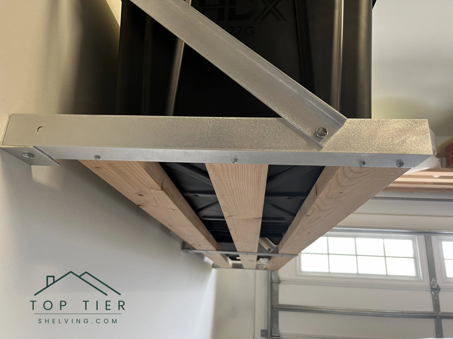 three 2x4 boards deep for each section of top tier small heavy-duty garage storage shelving